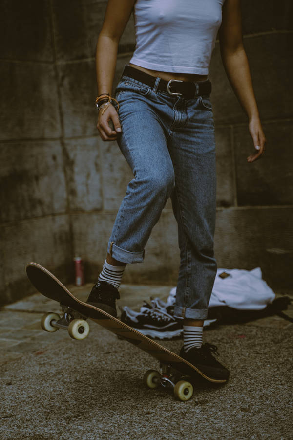Person In Blue Denim Jeans And Black And White Nike Sneakers Wallpaper