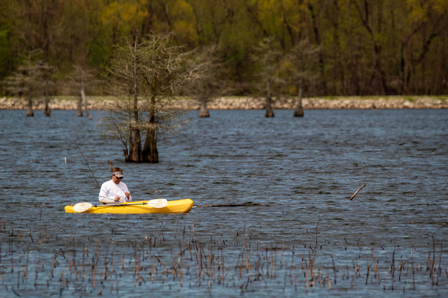 Person Riding Yellow Kayak On River During Daytime Wallpaper