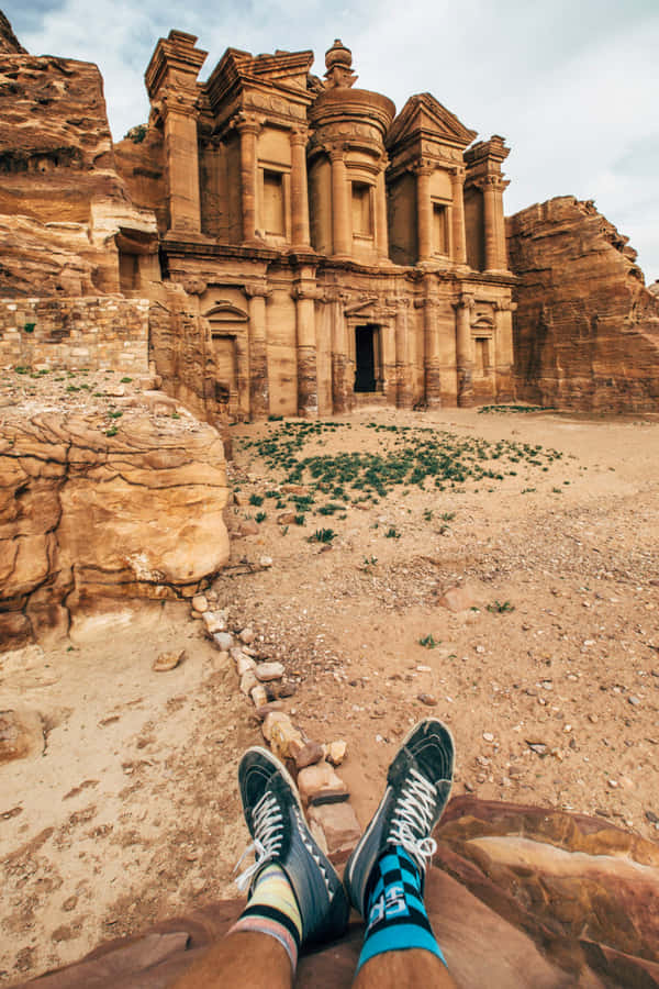 Person Shoes Against Petra Jordan Wallpaper