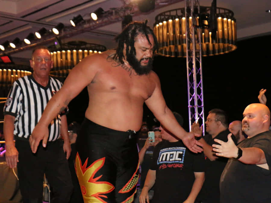 Powerhouse Wrestler Jacob Fatu Striking A Pose Wallpaper