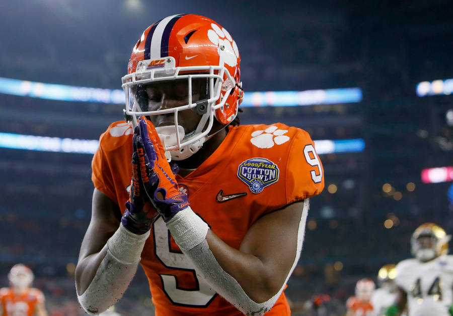 Praying Travis Etienne In Field Wallpaper