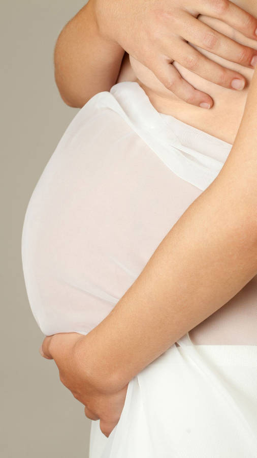 Pregnancy Covering Her Breasts Wallpaper