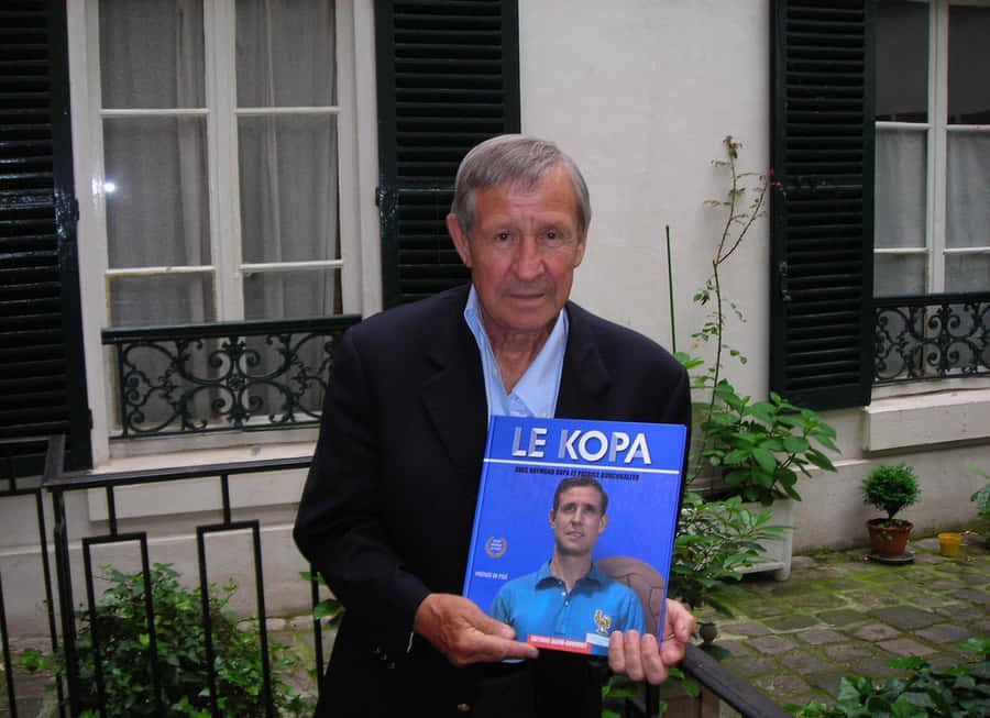 Raymond Kopa Holding Autobiography Wallpaper