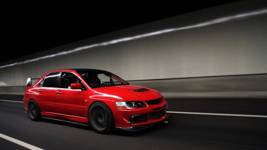 Red Mitsubishi Lancer Riding Wallpaper