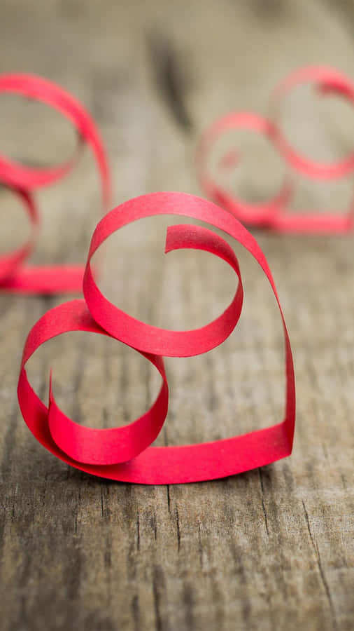 Red Paper Heart Shaped On A Wooden Table Wallpaper