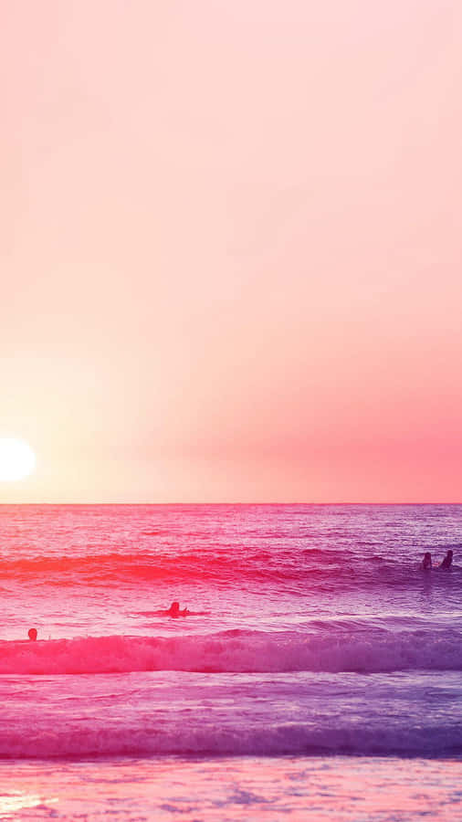 Relaxing At A Pink-hued Beach Wallpaper