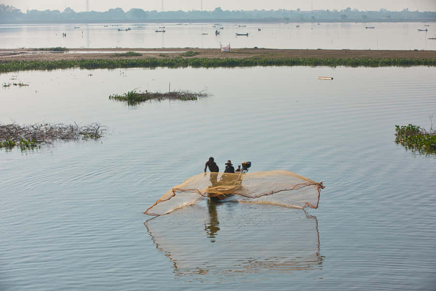 Residents Fishing In The Rivers Of Mandalay Wallpaper