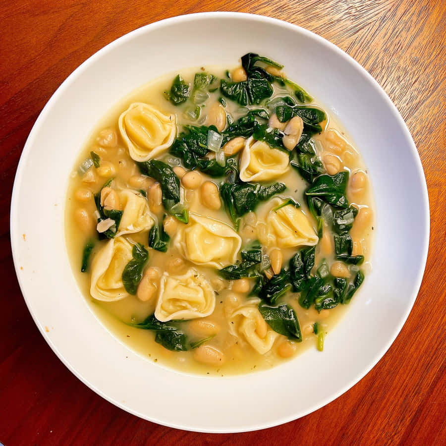 Savory Tortellini In Brodo With Spinach And Legumes Wallpaper