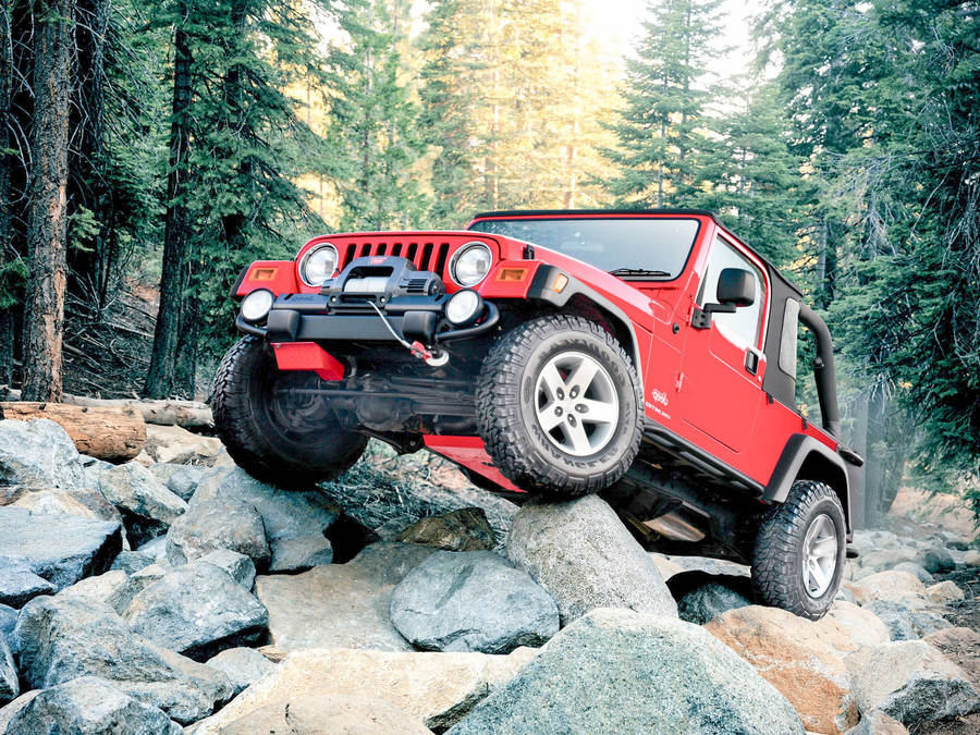 Scarlet Jeep In Rocky Forest Wallpaper
