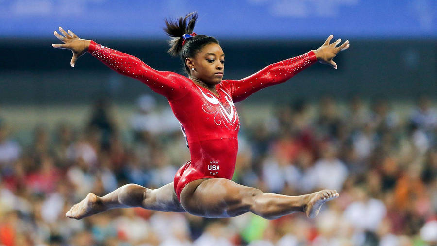 Simone Biles Powerful Split Jump Wallpaper