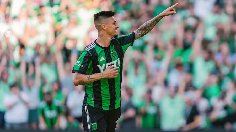 Soccer Player Celebratingon Field Wallpaper