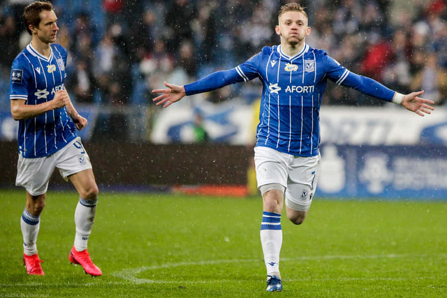 Soccer_ Player_ Celebration_in_ Rain Wallpaper