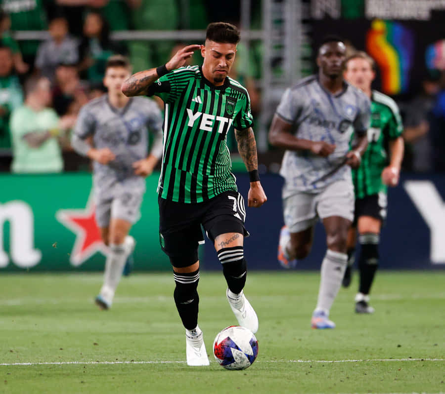 Soccer_ Player_ Controling_ Ball_ During_ Match Wallpaper