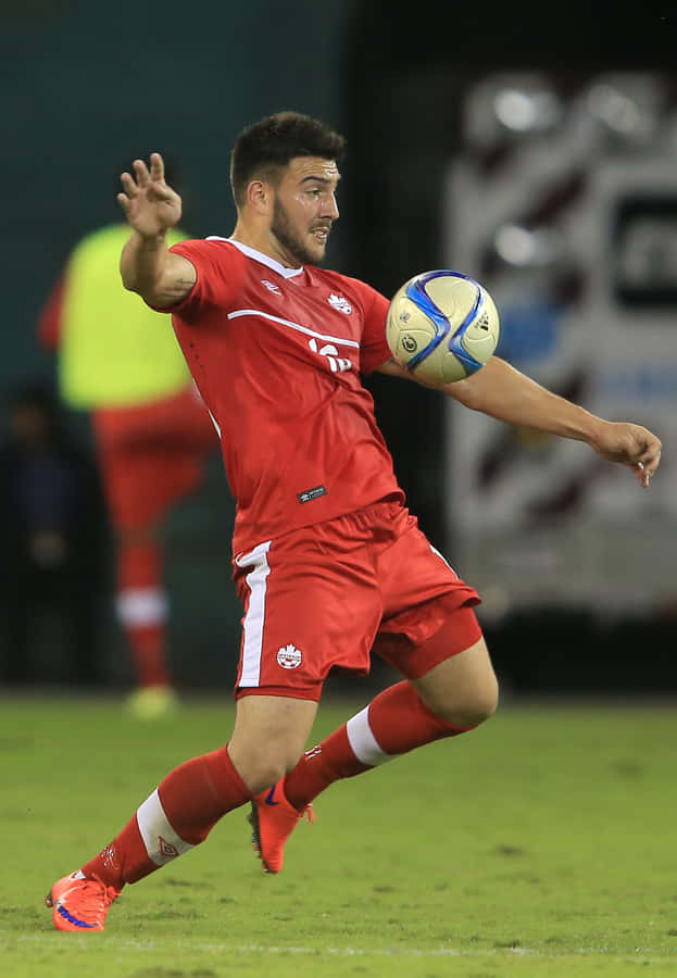 Soccer Player Controling Ball During Match.jpg Wallpaper