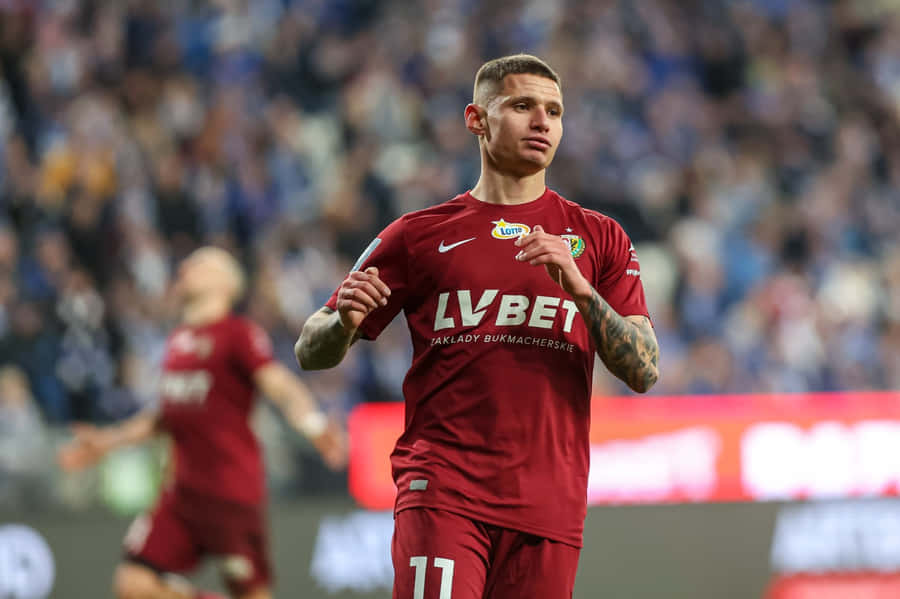 Soccer Player Patryk Klimala In Action Wallpaper