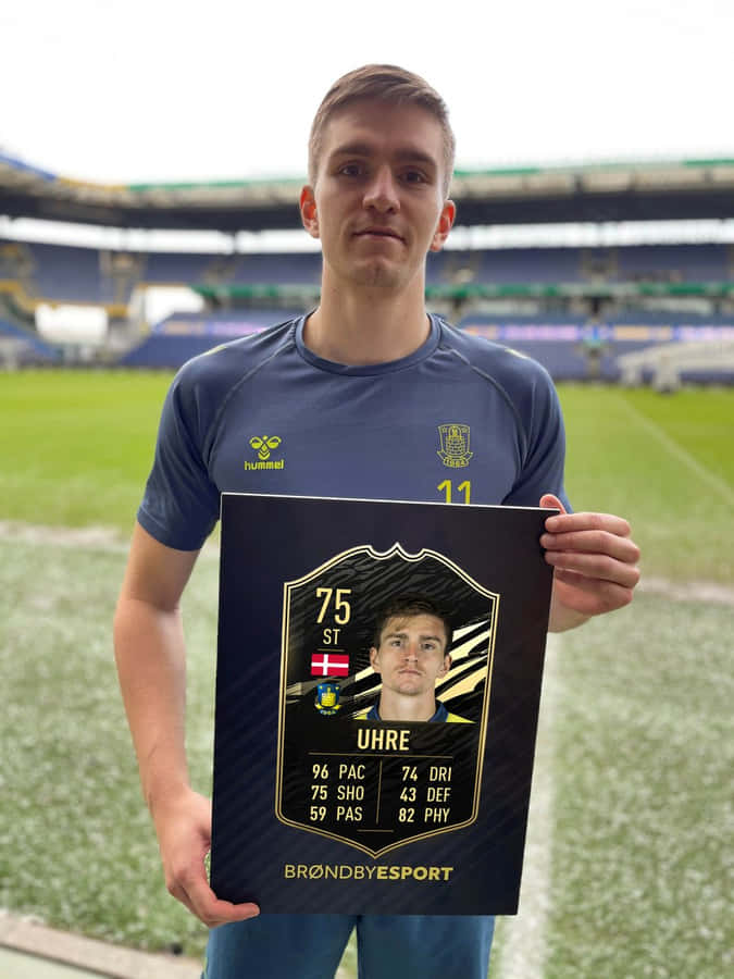 Soccer Player Uhre Holding F I F A Card Wallpaper