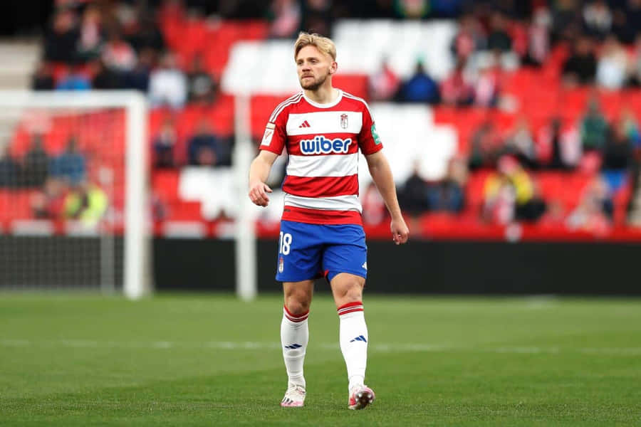 Soccer Player Walkingon Field Wallpaper