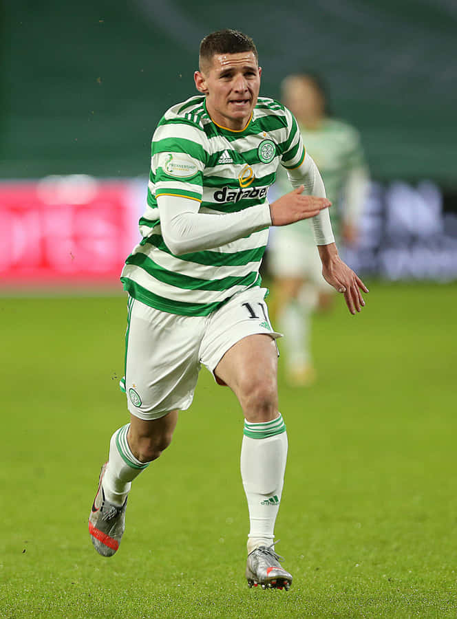 Soccer Playerin Action Green White Stripes Wallpaper