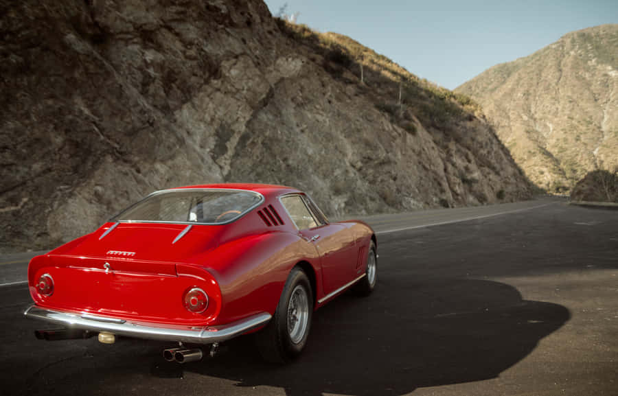 Speed And Style - Driving A Classic Ferrari Wallpaper