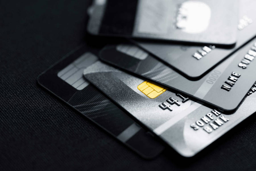 Stack Of Dark Colored Credit Cards Wallpaper