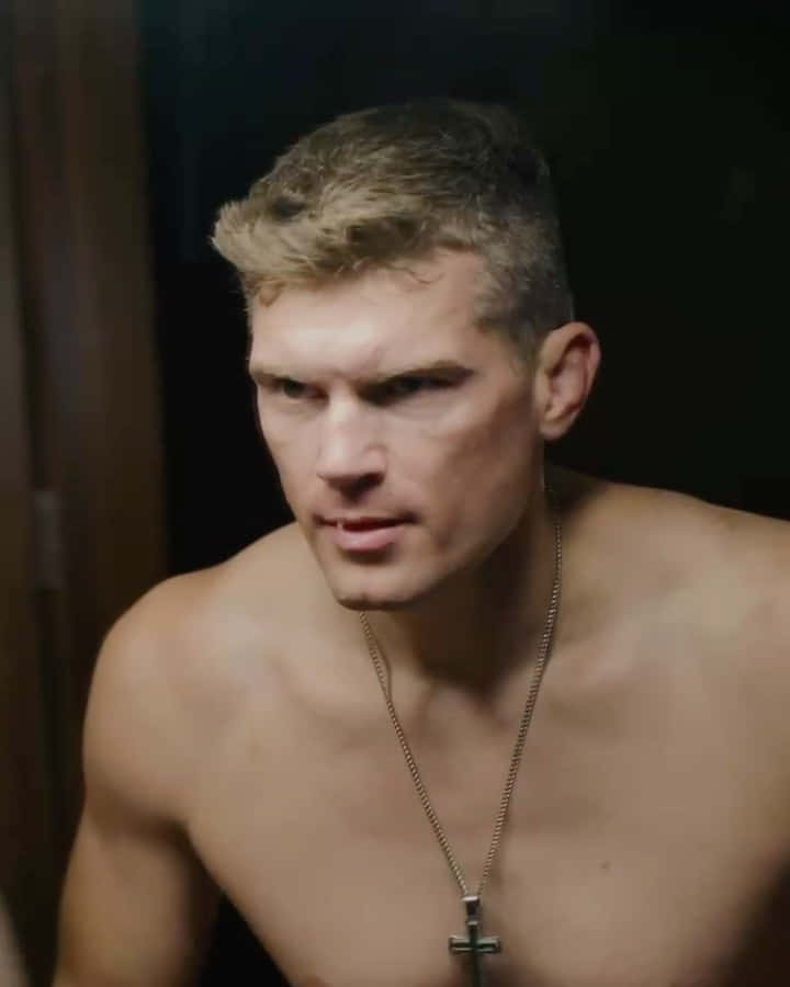 Stephen Thompson Delivering A Powerful Kick During A Martial Arts Competition Wallpaper