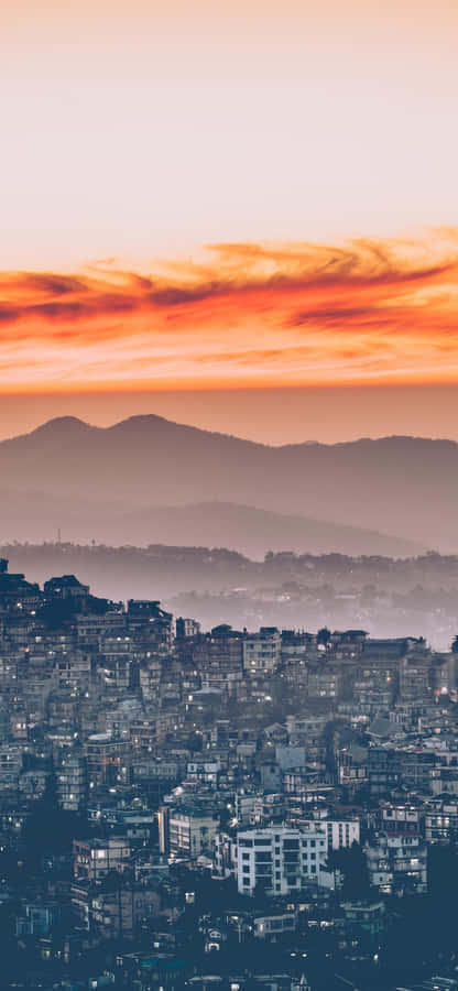 Take In The View Of A Beautiful City Sunset With Your Iphone. Wallpaper