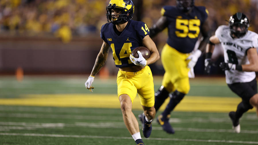 The Energetic Player Of University Of Michigan-ann Arbor Wallpaper