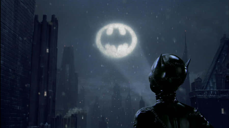 The Iconic Bat-signal Illuminating The Night Sky Over Gotham City Wallpaper