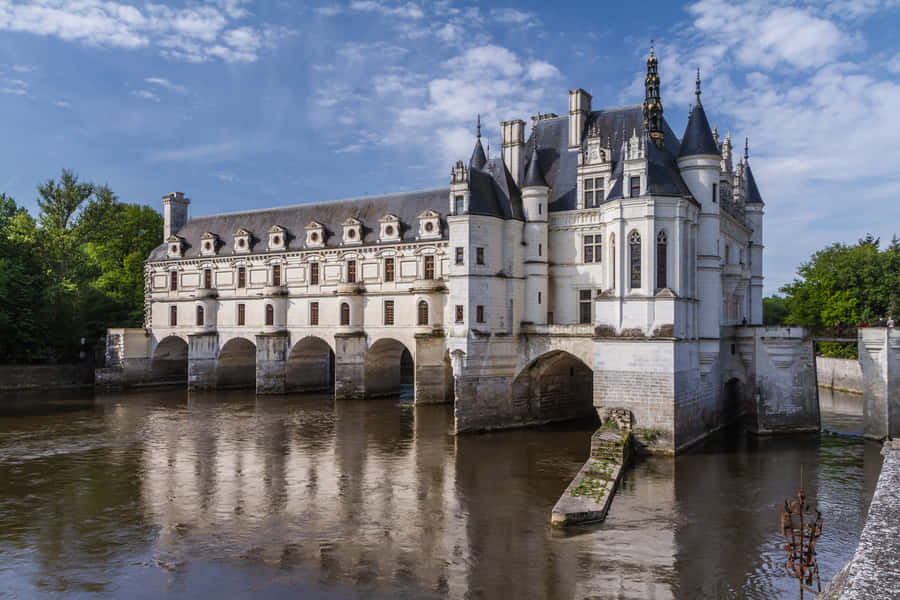 The Majestic Chenonceau Castle Over The Dark River Wallpaper