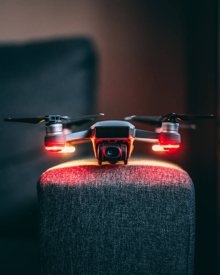 The New Age Of Technology: A Drone On An Armchair Wallpaper