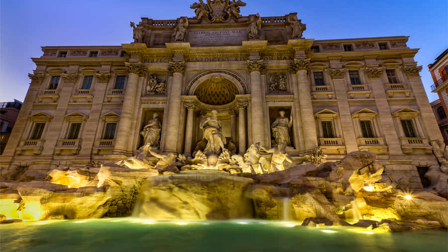 The Trevi Fountain Glistening In Golden Light Wallpaper
