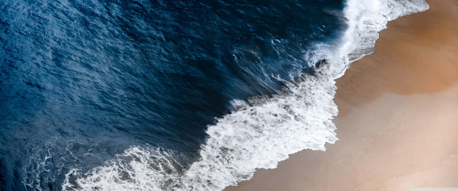 The Ultra Wide View Of A Magnificent Beach, Crystal Clear Waters And Dreamy Summer Sunsets Wallpaper