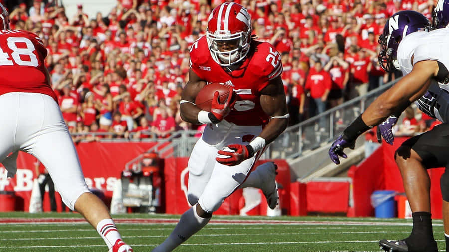 The Wisconsin Badgers Logo Displayed Proudly On A Stadium Field Wallpaper