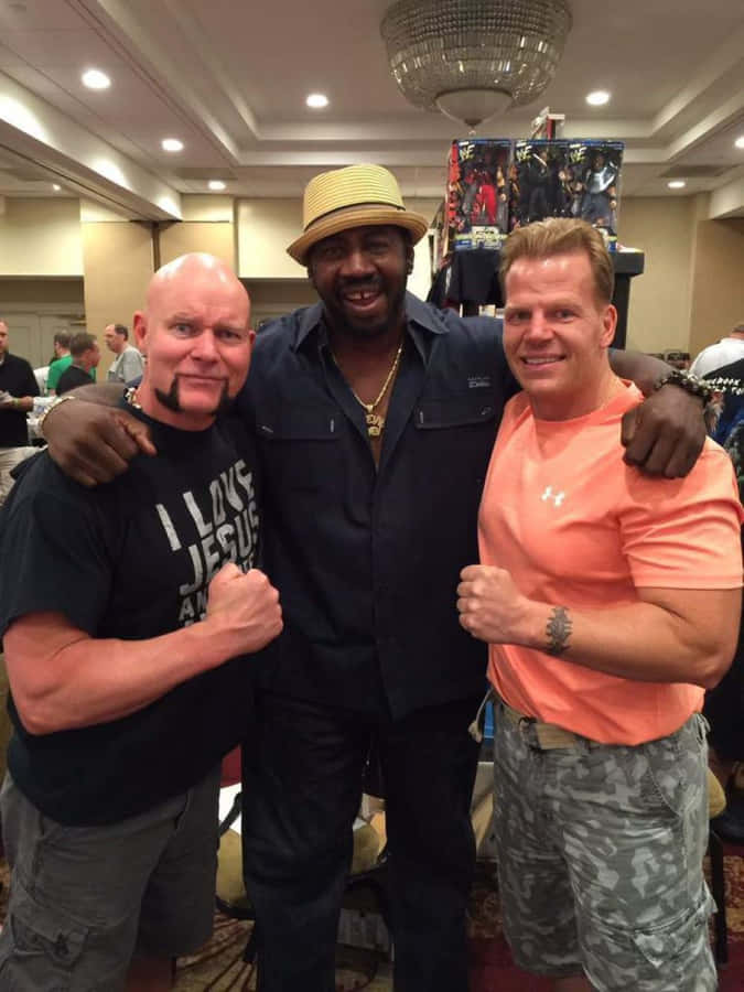 Three Men Posingat Event Wallpaper