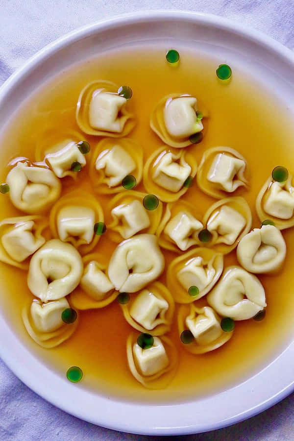 Tortellini In Brodo On A Purple Plate Wallpaper