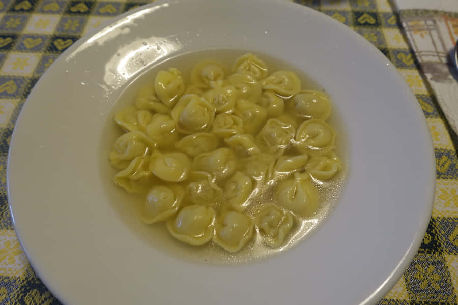 Tortellini In Brodo On A White Plate Wallpaper
