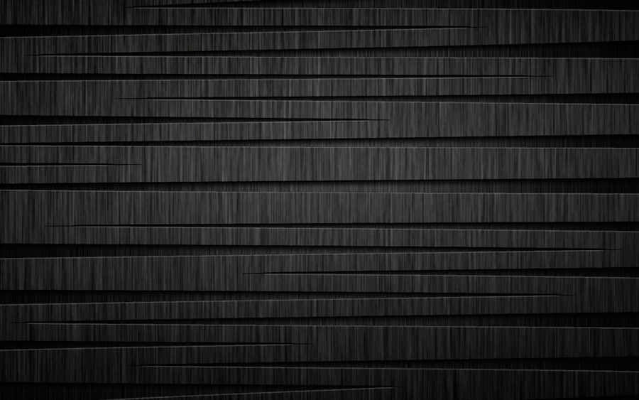 Two Black Metallic Cylinders Lying Against A White Backdrop Wallpaper