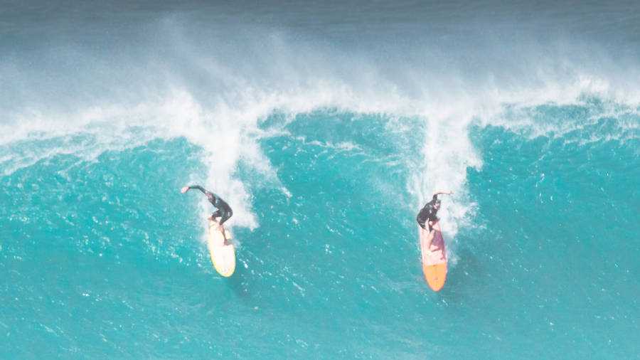 Two People Surfing Side-by-side Wallpaper