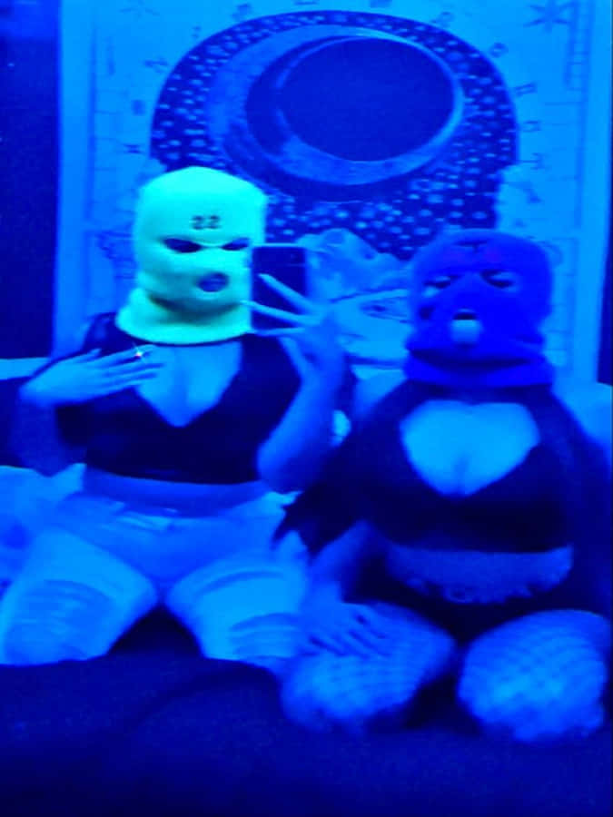 Two Ski Mask Girl Models Taking Selfie On Bed Wallpaper