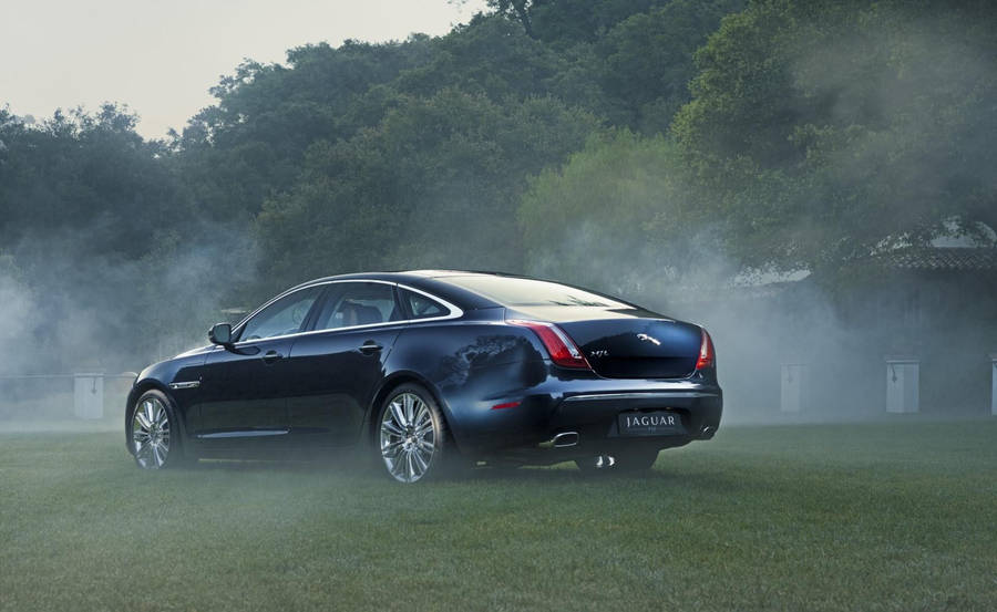 Unleash Your Power With The Smoky Black Jaguar Car Wallpaper