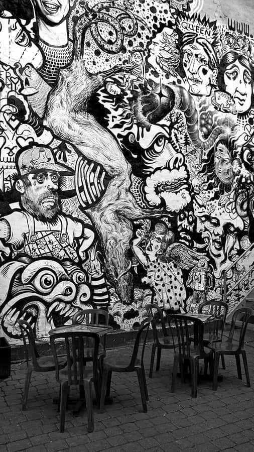 Urban Artistic Expression In Black And White Graffiti Wallpaper