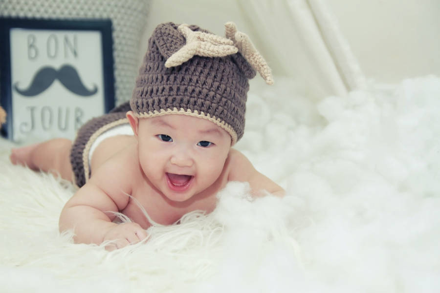 Very Cute Baby Wearing Beanie Hat Wallpaper