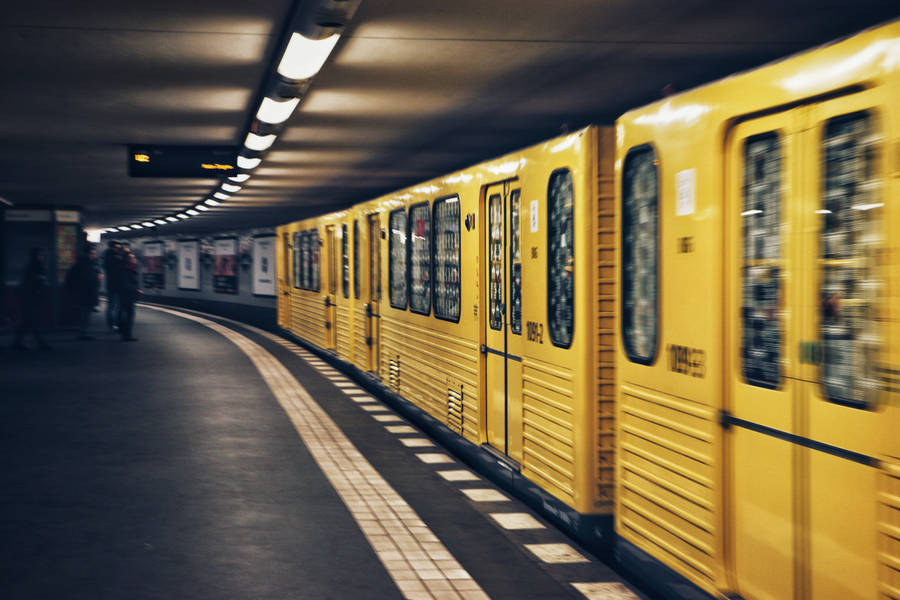 Vibrant Yellow Subway Train In Motion Wallpaper