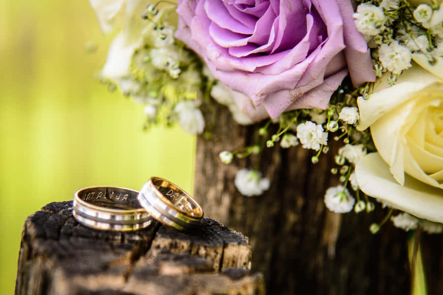 Wedding Ring On Wood With Flowers Wallpaper