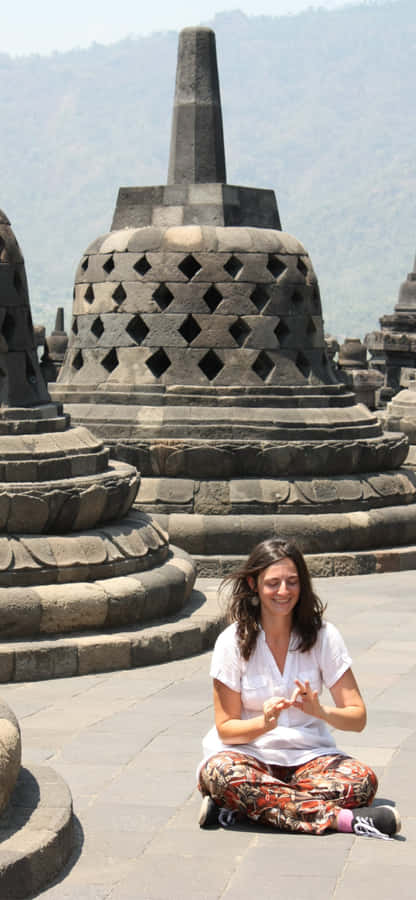 Woman Sitting On The Floor Of Borobudur Temple Wallpaper