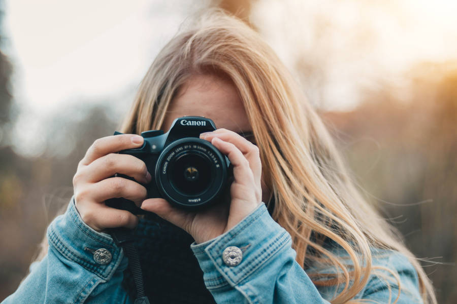 Woman Taking Photo During Daytime Wallpaper