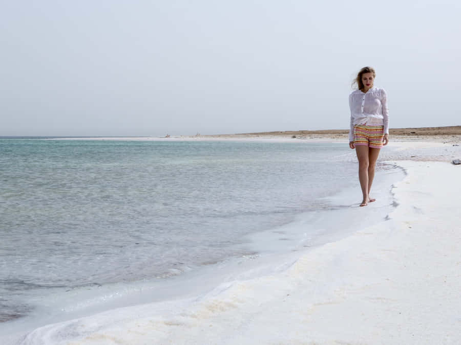 Woman Walking On Dead Sea Shore Wallpaper