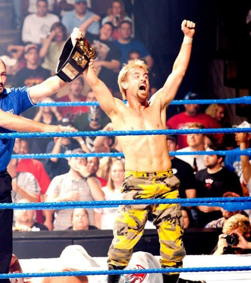 Wrestler Victory Celebrationwith Championship Belt Wallpaper