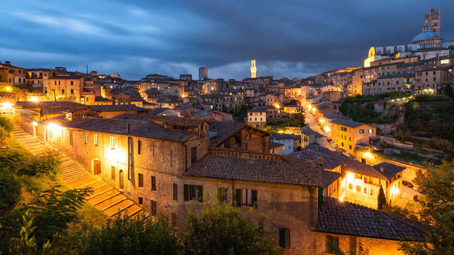 Yellow Lit Brick Houses In Siena Wallpaper