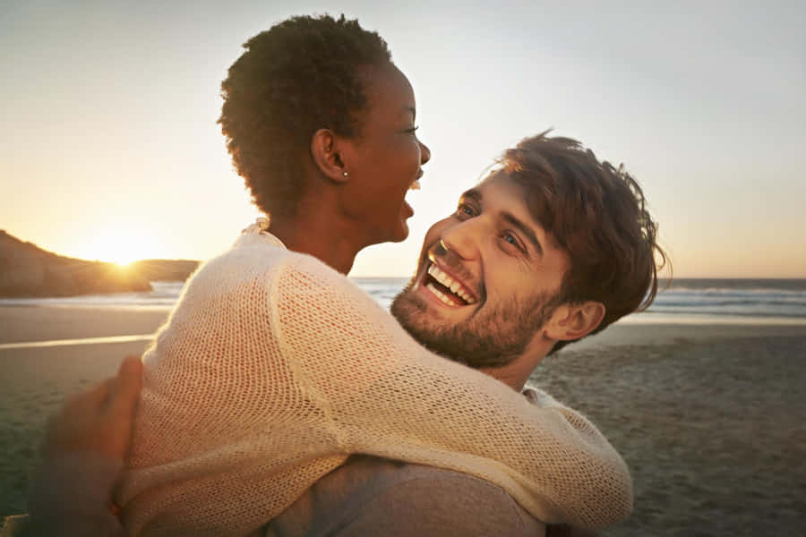 Young Couple Sharing A Romantic Moment Together Wallpaper